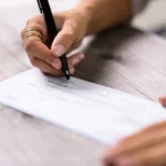 persona firmando documento bancario